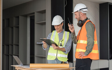 Wall Mural - Engineer team discussing meeting on plan at construction site