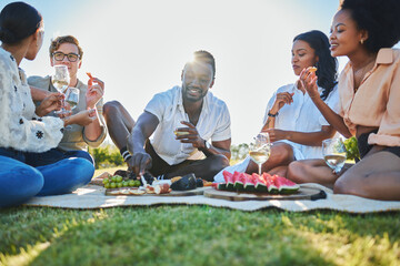 Friends, travel and picnic with food and outdoor in nature, fruit and cheese for nutrition and adventure in park. Wine, sun and summer holiday with social group, diversity and young people together.