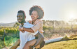© Kirsten D/peopleimages.com - Black couple, piggy back or bonding in park, nature garden or sustainability environment in fun activity game or love. Smile, happy man or afro woman in carry support, trust or freedom playful date