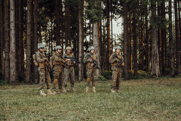 Wall Mural - Soldier fighters standing together with guns. Group portrait of US army elite members, private military company servicemen, anti terrorist squad