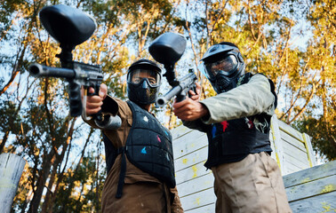 Wall Mural - Paintball, sports teamwork and men with gun for game, battle or competition. Collaboration, portrait or cooperation of people or friends on shooting range ready for target, aim practice and training