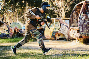 Poster - Paintball player or man running with gun, outdoor competition or games in forest adventure or military training. Army skill, fitness or sports person in shooting battlefield, action or target mission