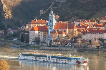 Wall Mural - Durnstein village during spring time with tourist ship on Danube river in Wachau (UNESCO), Austria