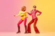© Lustre Art Group  - Young stylish emotional man and woman, professional dancers in retro style clothes dancing disco dance over pink-yellow background. 1970s, 1980s fashion, music concept