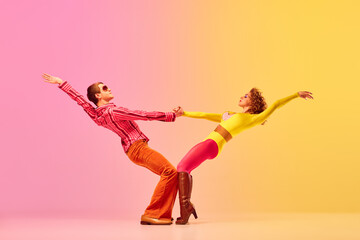young stylish emotional man and woman, professional dancers in retro style clothes dancing disco dan