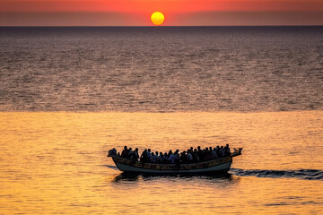 crowd of migrants and refugees on boat. illegal inmigration. generative ai