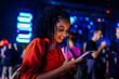 © bernardbodo - Girl texting at concert