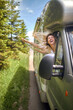 © luckybusiness - beautiful blonde enjoying the wind driving in the nature with her head out of the vehicle window, laughing