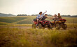 © luckybusiness - Friends driving quad bikes at the mountains