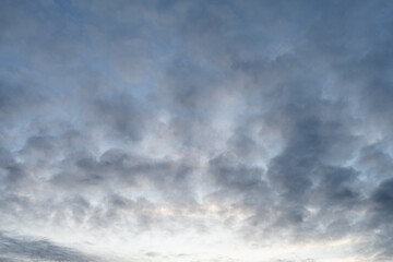 Wall Mural - Cloudscape at dusk time with soft light gray clouds.