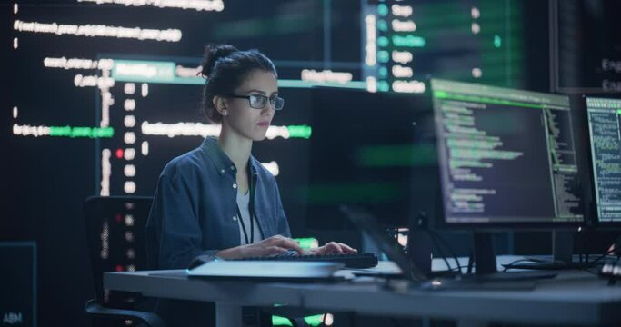 Fototapete - Female Programmer Working in Monitoring Control Room, Surrounded by Big Screens Displaying Lines of Programming Language Code. Portrait of Woman Creating a Software. Abstract Futuristic Coding Concept