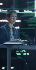 Wall Mural - Verical Screen: Female Programmer Working in a Monitoring Control Room, Surrounded by Big Screens Displaying Lines of Programming Language Code. Portrait of Woman Creating a Software and Coding