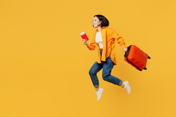 young woman wear summer casual clothes hold passport ticket bag jump high isolated on plain yellow b