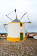 portuguese wind mill standing idle on a hilltop