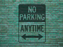 Green Grunge  Brick Wall With The Inscription: NO PARKING ANYTIME