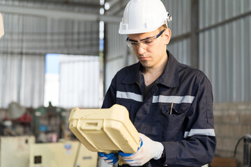 Aufkleber - Male engineer control robot arm by remote robot control in workshop. Male technician working with control automatic robot arm system welding. Industry robot manufacturing technology