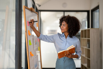 woman working while writting brainstorming on white board, making plans on board, business woman pla