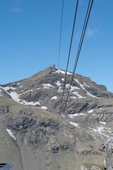 Sticker - Vertical shot of the ropeway hanging from the wires with mountains in the background