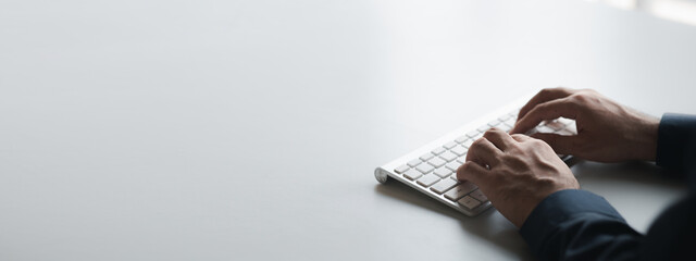 person typing on a computer keyboard, businessman is working in a startup company's office, he is ty