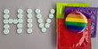 © Nadzeya - Inscription hiv with lgbt sign and condom