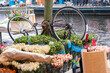upturned bicycle and flowers along a canal in Amsterdam