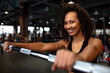 © Georgii - Sexy gorgeous african american woman training with barbell at the gym