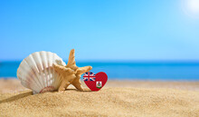 Beautiful Beach In The Bermuda. Flag Of Bermuda In The Shape Of A Heart And Shells On A Sandy Beach.