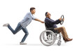© Ljupco Smokovski - Full length profile shot of a guy pushing a mature man in a wheelchair holding a steering wheel