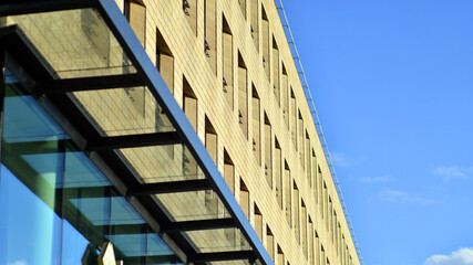 Wall Mural - Detail of a modern yellow brick building with large windows.