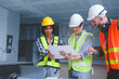 © NanSan - Group of multi ethnic engineer construction site worker meeting at workplace, Architects working together at construction site to remodeling home or building.