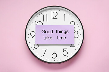 Wall Mural - Card with phrase Good Things Take Time and clock on pink background, top view. Motivational quote