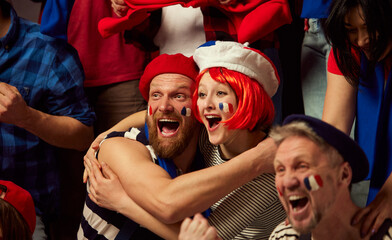 Happiness. Football, soccer fans emotionally cheering up favourite france team. People wearing country's attributes, scarves and paints. Concept of sport, cup, world, team, event, competition