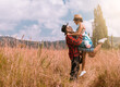 © Germán Camelo - Sunny Romance: Man Holding Woman Up in Golden Field on Summer Day
