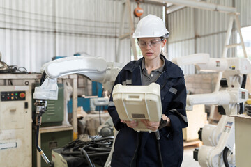 Aufkleber - Female engineer control robot arm by remote robot control in workshop. Woman technician working with control automatic robot arm system welding. Industry robot manufacturing technology