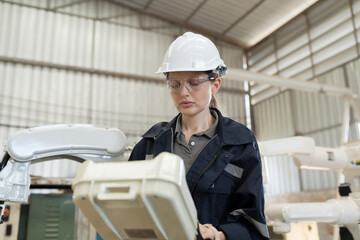 Aufkleber - Female engineer control robot arm by remote robot control in workshop. Woman technician working with control automatic robot arm system welding. Industry robot manufacturing technology