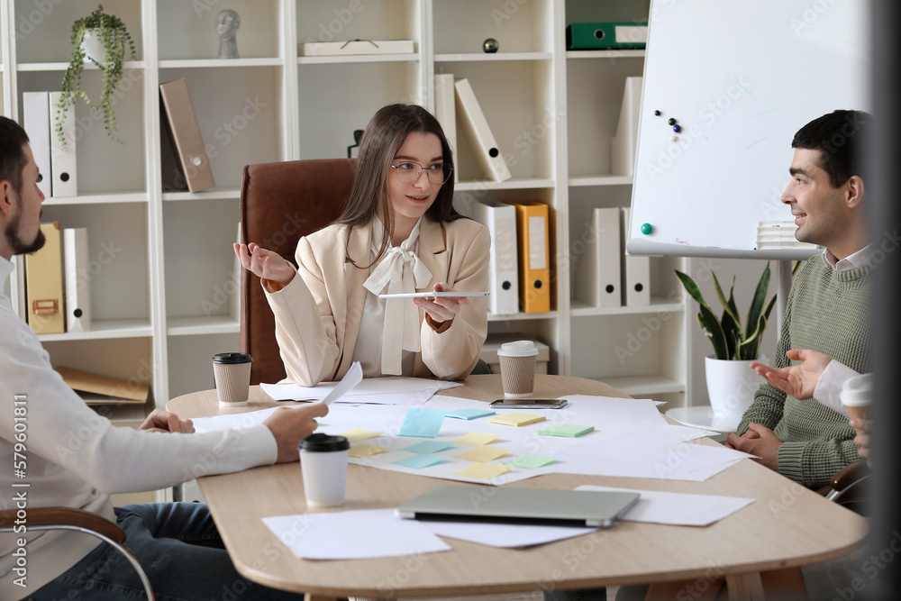 Group of people working on business plan in office