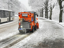 Small Snow Plough In Winter Clears Pavement And Bike Path