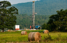 Drilling Rig On Grassy Field Against Mountain In Arkoma Basin