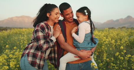 Wall Mural - Family, farm and a couple with child in field of flowers, happy, sustainable and together. Man, woman and kid, sustainability countryside farmer in nature farming with trust and support for future.