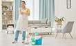 © Anela R/peopleimages.com - Happy woman cleaning home floor, house work and smile in home service mopping living room, job with gloves and happy to clean house apartment. Portrait of Asian cleaner or housewife housekeeping