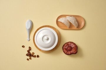 Canvas Print - Flat lay of a white bowl, a wooden dish of edible bird’s nests, jujube (ziziphus jujuba) slices and Lingzhi mushroom (Ganoderma Lucidum). Healthcare concept.