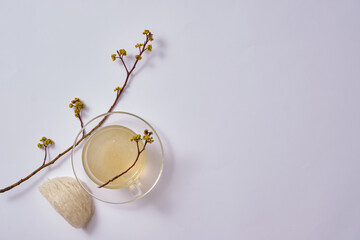 Canvas Print - A glass transparent cup containing bird’s nest soup, decorated with an edible bird’s nest and flower branches. Bird’s nest can enhance disease prevention system. Blank space to display product