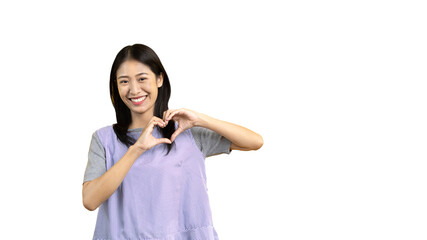 Asian young woman with bright smile making heart symbol shape with hands, Symbol of love and romance, Give each other cuteness and create smiles for each other, Positive thinking concept.