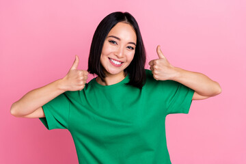 Poster - Photo of adorable girlish cute girl with bob hairdo dressed green t-shirt showing like thumbs up isolated on pink color background