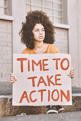 Wall Mural - City, human rights and woman with cardboard sign, student protest in support of women, time for change or action. Freedom, justice and equality, sad angry girl with banner for empowerment on street.