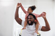 enjoy happy love black family african american father carrying daughter little african girl child smiling and having fun moments good time. Happy black African American father day concept.
