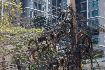 messy electric wire outdoor in public street in Bangkok, Thailand.