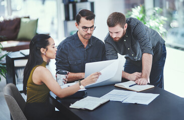 Poster - Putting their heads together as innovators. Shot of a group of young designers having a discussion in an office.