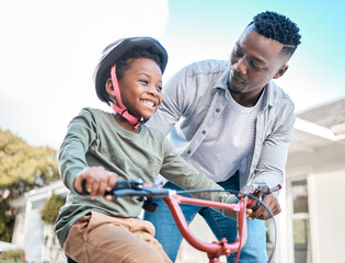 Sticker - Look at him go. Shot of a father teaching his son to ride a bicycle outdoors.