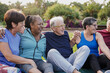© Sabrina - Multiracial senior friends having fun together at park after yoga exercise class